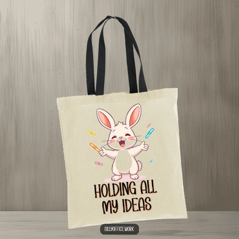 Funny tote bag: A cheerful bunny excitedly juggles colorful paper clips, capturing a moment of hilarious office organization.